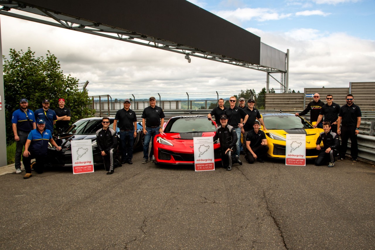 group of people with 3 corvettes at nurburgring
